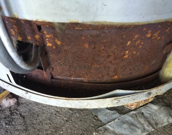 Rusted bottom of a water heater tank