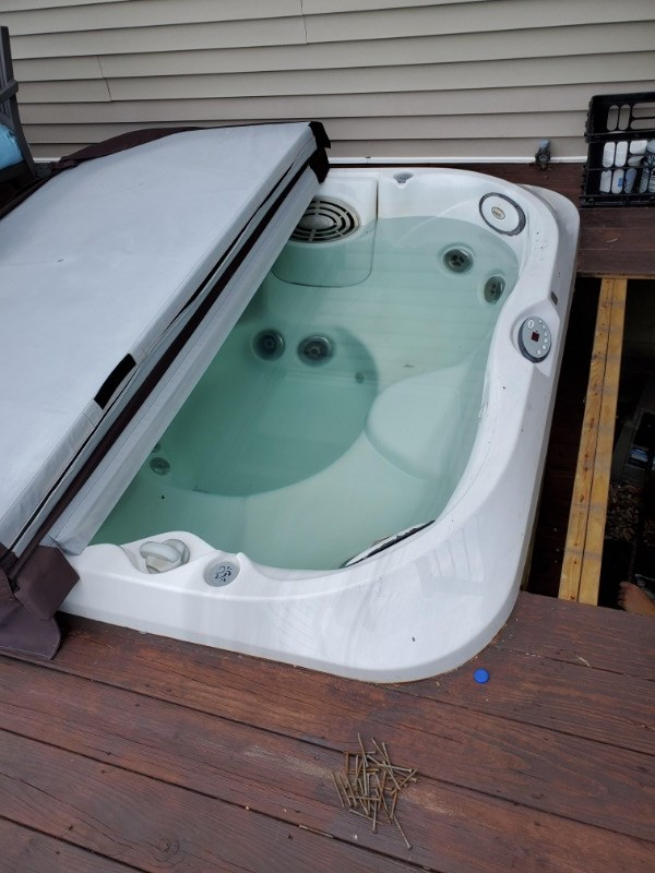 A hard-shell hot tub in a deck